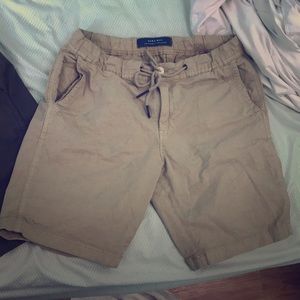 A pair of shorts , tan and green
